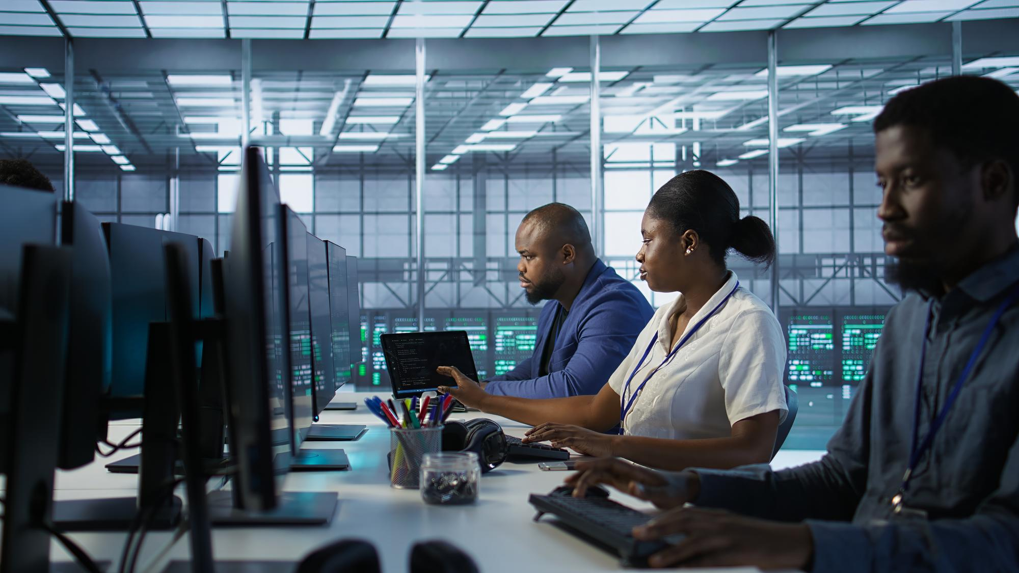 Operations team monitoring government systems in a modern command center